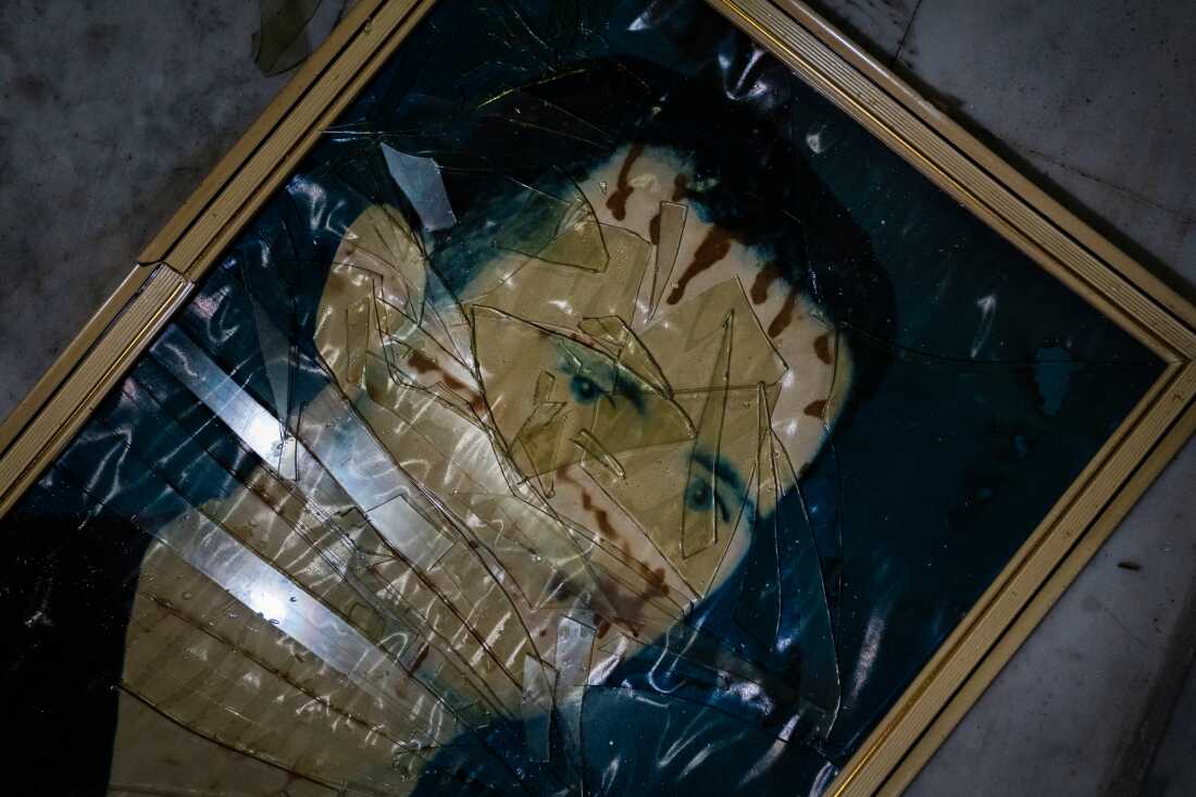 A picture of Assad lies shattered on the floor of the the former Air Force Intelligence building in Damascus.