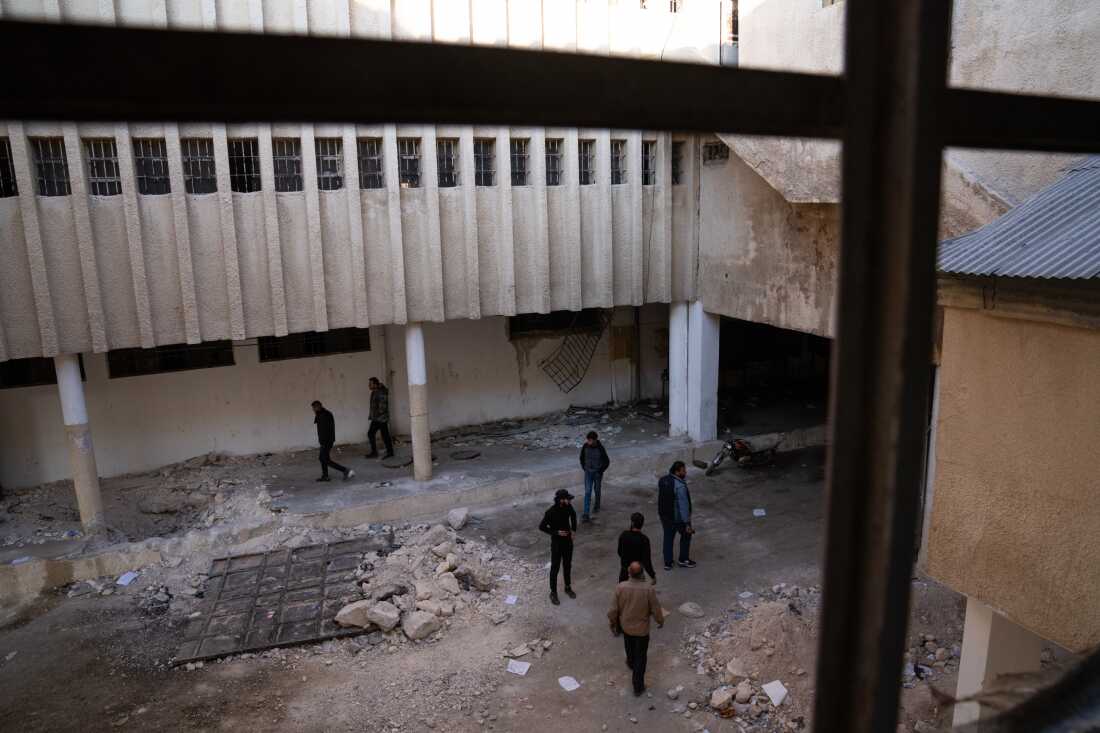 People looking for missing family members walk through Sednaya prison, just North of Damascus, where the Assad regime detained and tortured people.