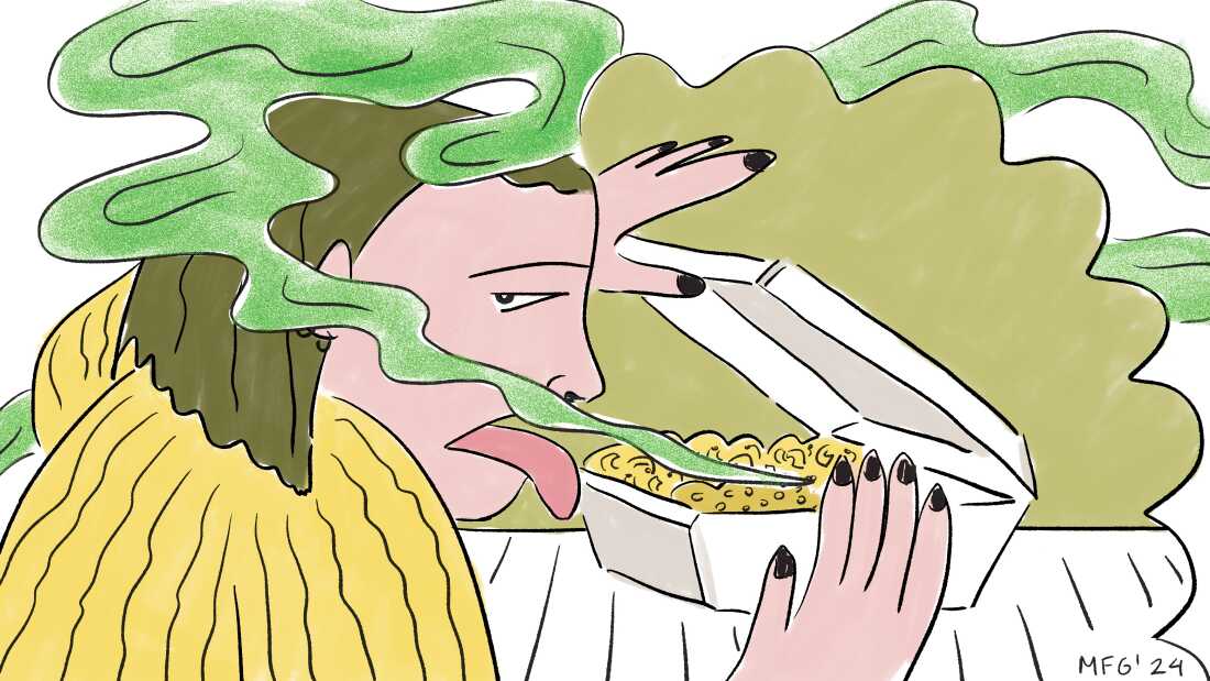 A woman smells a takeout container of food and is disgusted. 