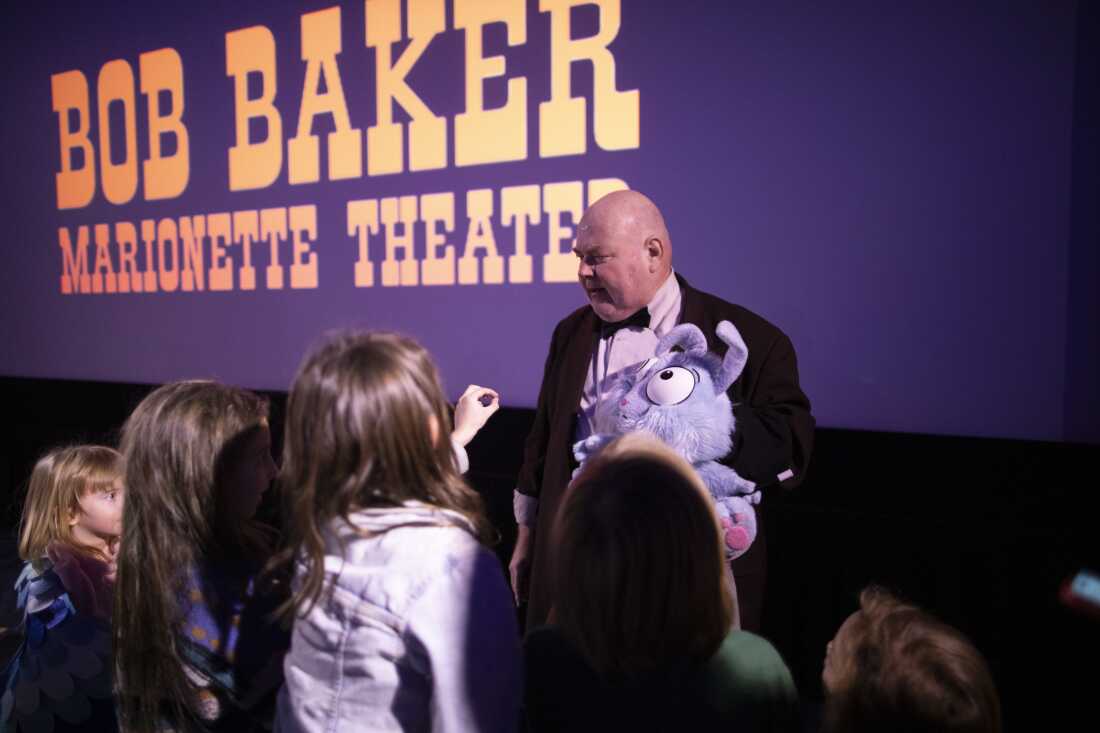 Buster Balloon shows off a puppet to children at the Vidiots theater.
