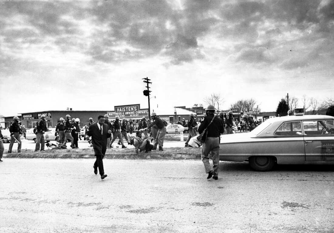 Hosea Williams, left, who led a march in Selma, Ala., leaves the scene as state troopers break up the demonstration on what is known as Bloody Sunday on March 7, 1965.