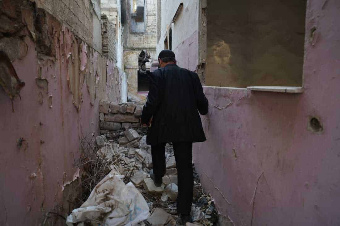 Ayman al-Masri wanders through the destroyed streets of Homs, Syria, on Feb. 1.