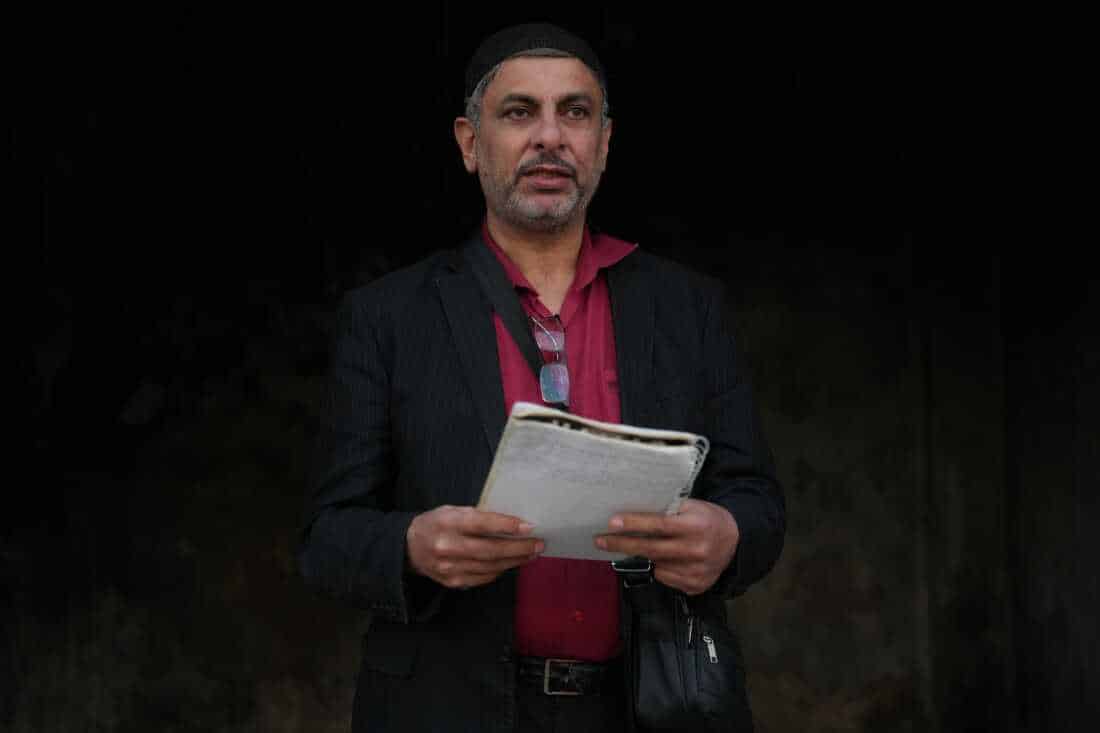 Ayman al-Masri carries a notebook where he hand-wrote songs, in Homs, Syria, on Feb. 1.