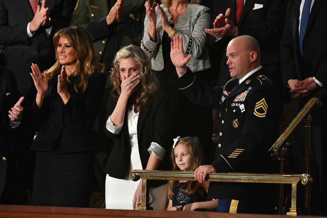 Sgt. Townsend Williams (at right) waves next to his children after returning from deployment in Afghanistan as his wife Amy (second from left) looks on during the 2020 State of the Union address at the U.S. Capitol.