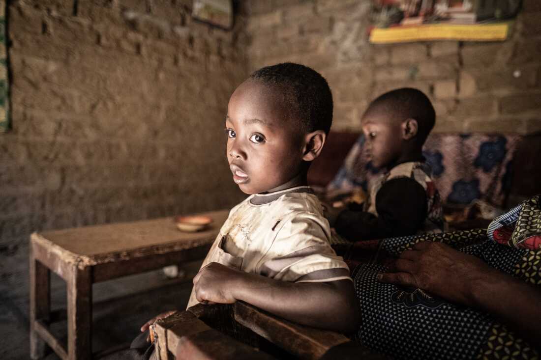 Ethan Kaunda, 4 (r), looks out of the doorway of his home in the lead-contaminated neighbourhood of Magandanyama in Kabwe, Zambia. Ethan suffers from lead poisoning that has left him with cognitive impairment and other health problems. In Magandanyama and other lead poisoning hotspots in the town, lead is in the dust, and is virtually impossible to avoid. Over a century since lead mining operations began in the town, very little has been done to address the lead contamination.