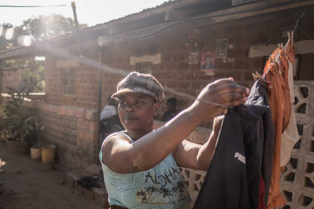Mable Besa, 49, hangs up laundry on her washing line in the lead-contaminated neighbourhood of Magandanyama in Kabwe, Zambia. Nearly a century of lead mining and smelting in the town has left Magandanyama's dust with extreme levels of lead. Beta lives with two of her grandchildren, both of whom suffer from lead poisoning. “It’s not manageable to just stop the children from playing outside," she says. "If you wash their clothes, they gather dust when you hang them up. Even inside the house, if you leave food in the pots, you will find dust there.” Beta lives with two of her grandchildren, both of whom suffer from lead poisoning.