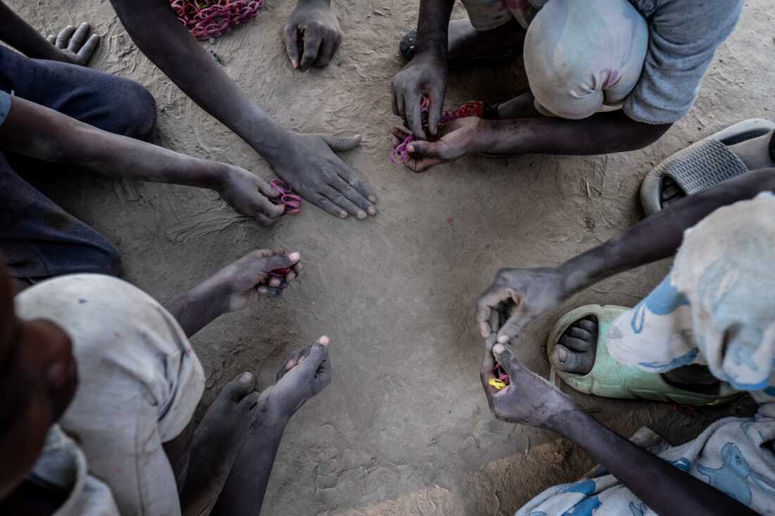 Children play a game in the lead poisoning hotspot of Magandanyama in Kabwe, Zambia. Nearly a century of lead mining and smelting has made the town's dust highly toxic. In neighbourhoods like Magandanyama, that dust continues to have a devastating impact on children's health today, thirty years after the closure of the mine. Lead poisoning can lead to a raft of health issues from permanent cognitive impairment to liver and hearing problems, increased rates of miscarriage in pregnant women, and death. Children are worst affected, partly because their brains are still developing, and partly because they tend to ingest far more dust than adults.