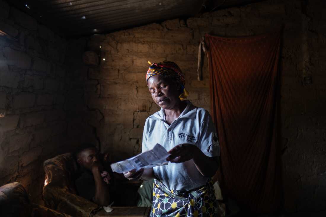 Community Health Mobilizer, Rose Asabi, 58, scans through a list containing the details of the 515 children from her immediate area who are suffering from lead poisoning, in Kabwe, Zambia. Asabi lives in Magandanyama, one of the neighbourhoods worst affected by lead contamination caused by decades of mining and smelting in the town. Asabi's own grandchildren all have blood lead levels of between 45 and 89 micrograms per deciliter, a level that requires urgent medical treatment - the safe limit is considered to be no more than five. Lead is a powerful neurotoxin that can cause serious brain, hearing and liver damage, increase the risks of miscarriage, and can even prove fatal. "We're scared," she says. "The soil is contaminated. The environemnt is a threat to the people living in it."