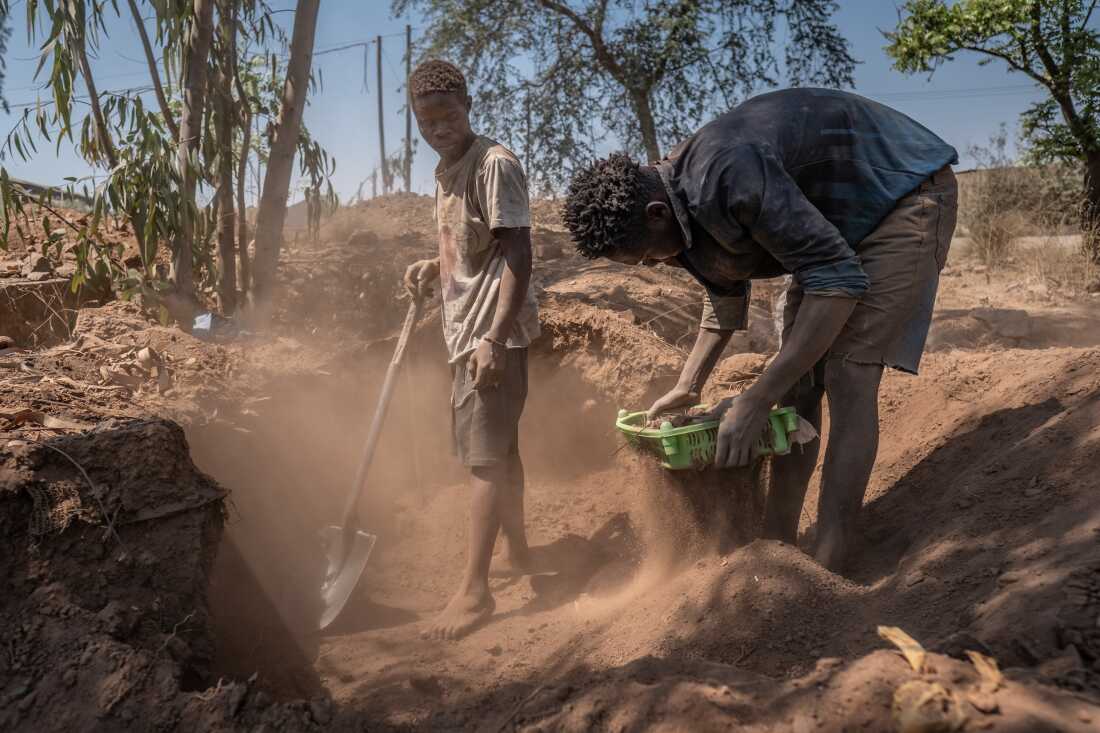 Artisanal miners Mike Kunda (l) and Jacob Phiri work on the site of the former Broken Hill lead and zinc mine, in Kabwe, Zambia. Thirty years after the mine's closure, the earth remains heavily contaminated, with lead levels in the soil up to 100 times higher than the safe limit. Yet faced with a shortage of jobs, many in the town feel they have little choice but to try to make a living searching for minerals here. Using little more than their bare hands and some basic tools, they expose themselves daily to dangerously high levels of lead.