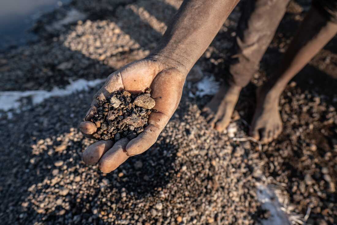 A boy displays pieces of lead mined from the site of a former industrial lead mine in the town of Kabwe, Zambia. Lead levels in the blood of children surveyed in the area averaged nearly ten times higher than the CDC's benchmark for what constitutes abnormal levels.
