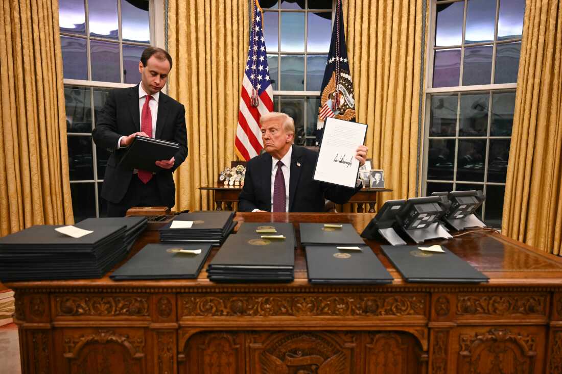 President Donald Trump signing executive orders in the Oval Office of the White House in Washington, DC, on January 20, 2025.