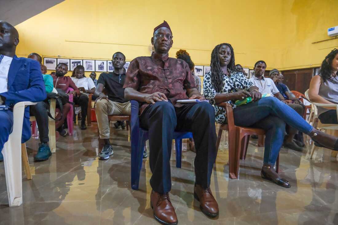 Bissau, Guinea-Bissau (September 23, 2024) - Antonio Queba Banjai, a direct descendant of the last Emperor of Kansala and President of Guinea-Lanta!, an NGO that collaborated with the archeological dig in Kansala, listens to the presentation of the findings at Guinea-Bissau's National Institute of Study and Research, INEP.