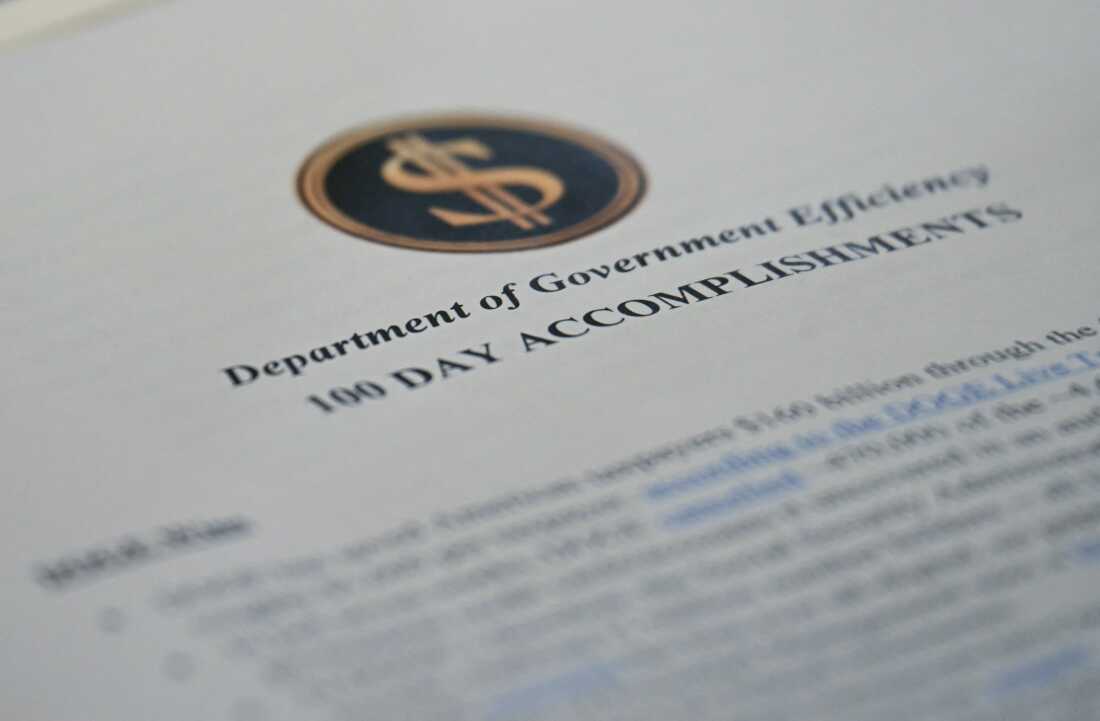 A report on cost cuts made by what's known as the Department of Government Efficiency on the Cabinet Room table at the White House on April 30, 2025.