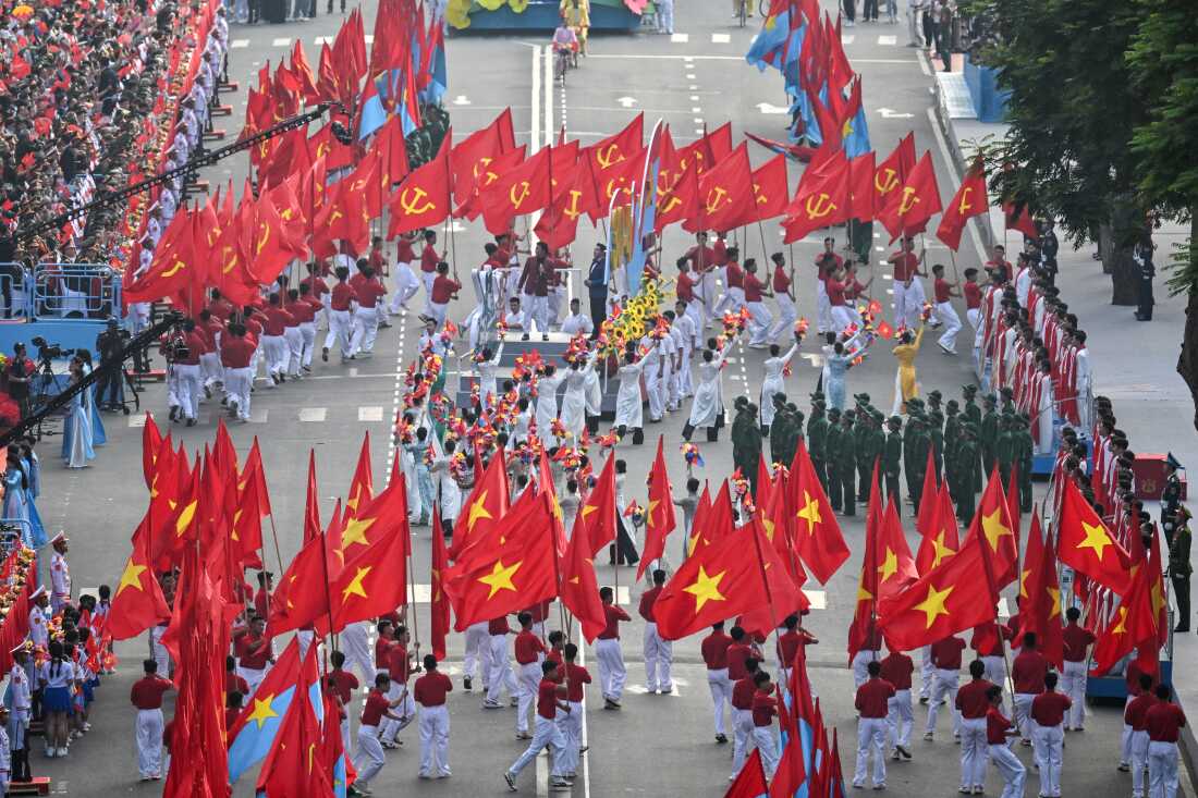 Participants perform during a parade marking the 50th anniversary of the fall of Saigon and the end of the Vietnam War in Ho Chi Minh City on April 30, 2025.