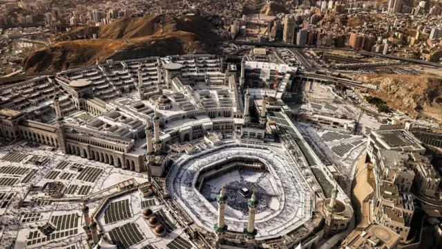 منظر لمكة مع المصلين المسلمين في مجمع المسجد الحرام. حيث يظهر صحن الكعبة في صورة جوية التقطت نهاراً.