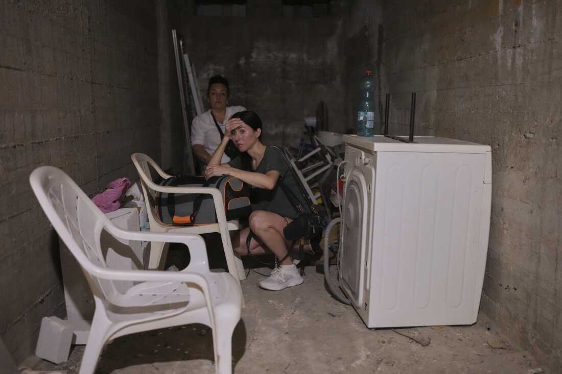 Israelis stay in a shelter of a residential area that was hit by a missile fired from Iran, in the central Israeli city of Bat Yam, early Sunday, June 15, 2025. (AP Photo/Ohad Zwigenberg)