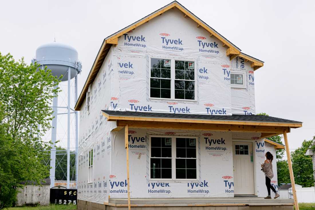 Becca Morris stands on the front porch of her future home, in Harrington, Delaware, on Wednesday, May 14, 2025. (Wesley Lapointe/ for NPR)