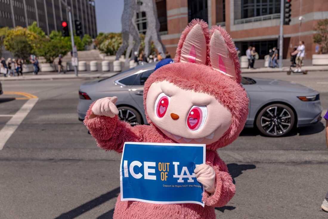 A protester wearing Labubu costume holds a placard calling on ICE to leave LA as protesters continue anti-ICE demonstrations on the second day in Los Angeles on June 7.