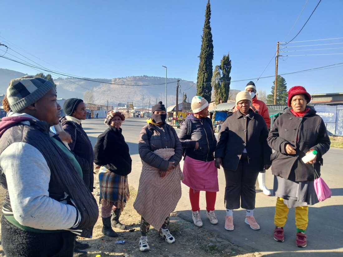 Maqajela Hlaatsane, far right, talks to other women looking for work outside a garment factory in Maseru, Lesotho, on July 15, 2025.