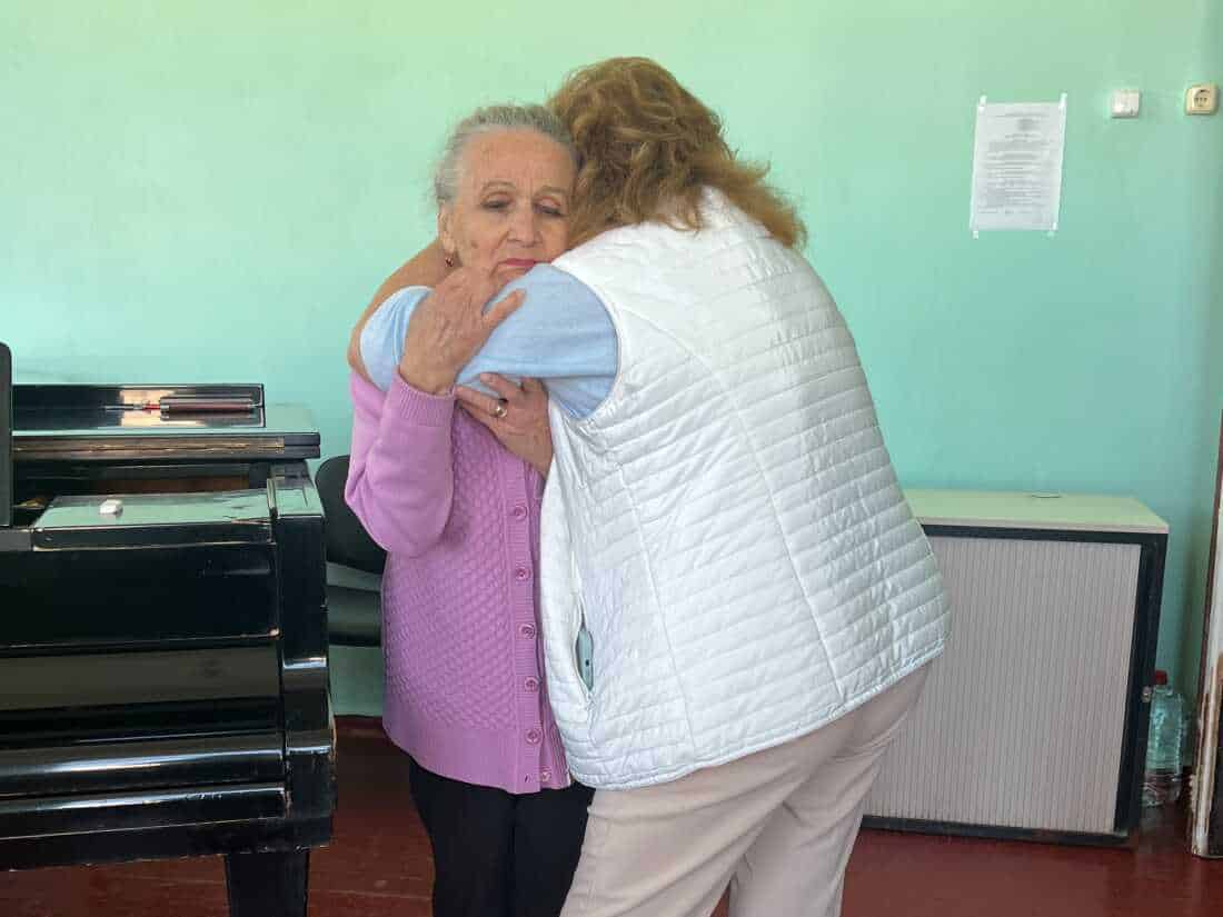 Classical voice teacher Natalia Tsylbulko embraces Nadia Hryn, who runs Sumy's music conservatory. Tsybulko's daughter Olena Kohut, killed in a Russian missile attack in April, used to teach at the school along with her mother. “The horror and cruelty, we feel it every day,” Hryn said.