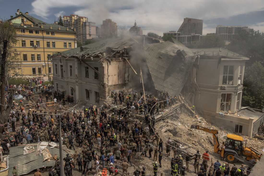 Emergency and rescue personnel along with medics and others clear the rubble of the destroyed building of Ohmatdyt Children's Hospital following a Russian missile attack in the Ukrainian capital of Kyiv on July 8, 2024, amid Russian invasion in Ukraine.