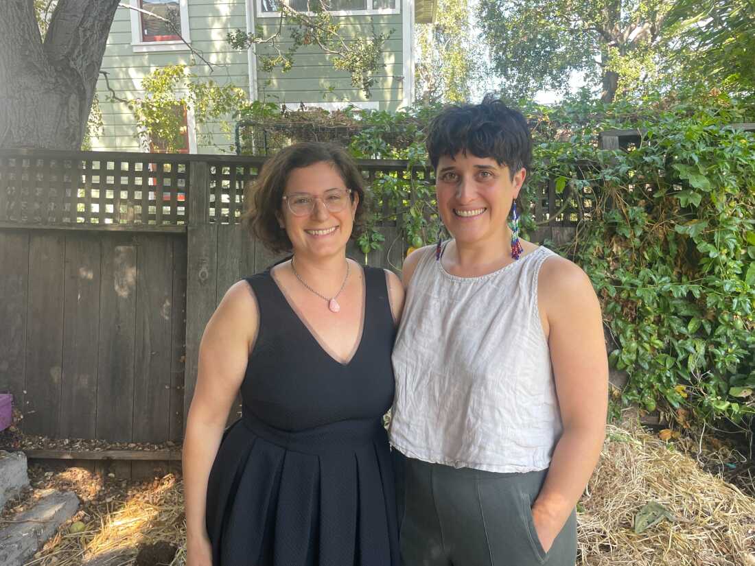 Friends Tammy Kremer (left side of the frame) and Hayley Currier stand next to one another outdoors.