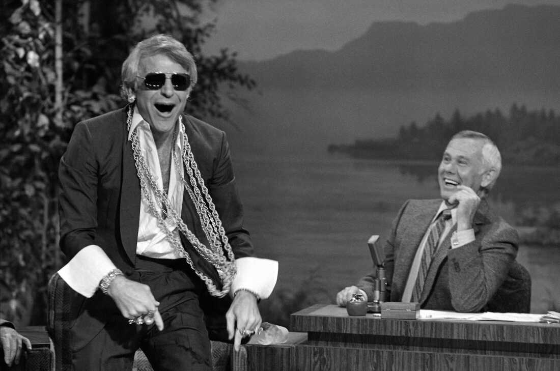 Steve Martin appeared on The Tonight Show Starring Johnny Carson in July 1980, wearing fake jewelry to poke fun at his own success.