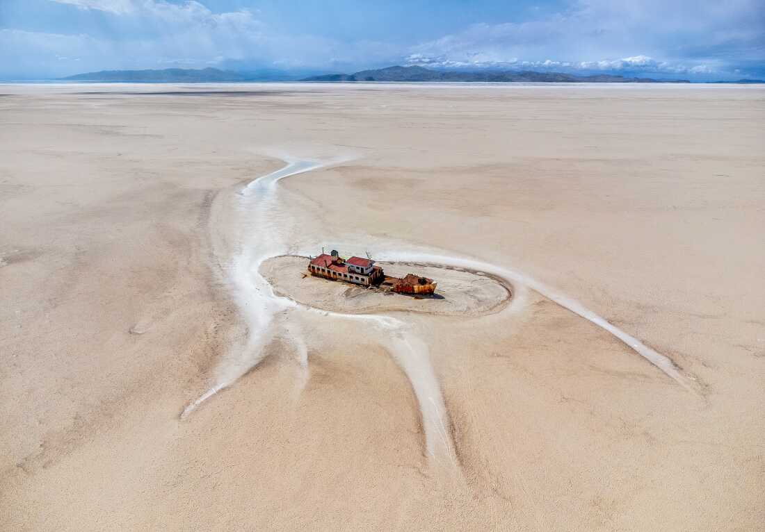 The Artemia pleasure boat stands marooned in the dried bed of Lake Urmia, Iran—trapped in a crater eerily shaped like a monster’s belly. Years of drought, mismanagement, and agricultural overuse have drained the lake, leaving behind symbols of its forgotten past.