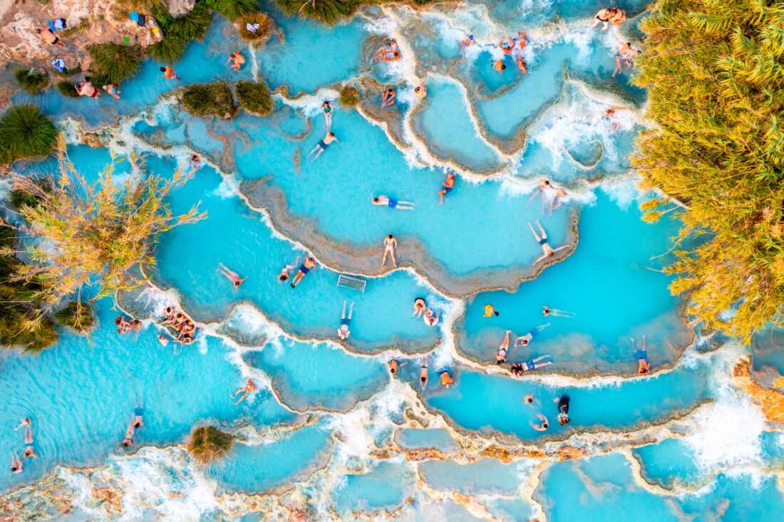 Miniature Paradise by Gilad Topaz The Cascate del Mulino hot springs in Tuscany, during a cold evening. Many people enjoy the hot water, and from above, they look like miniature figures. Gilad was astonished by the beautiful blue water and by the number of people, despite the cold temperature outside.