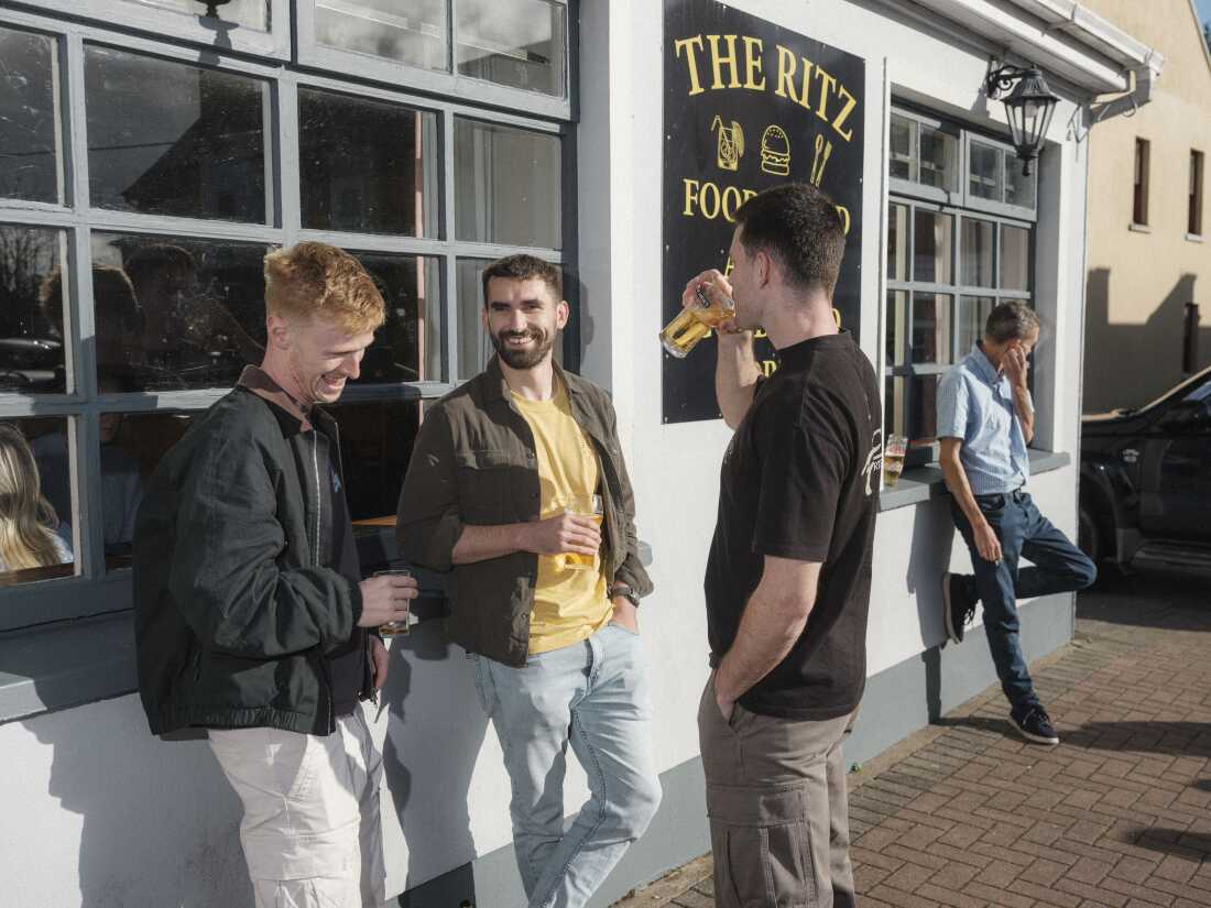 Festivalgoers Liam Shivers, Mike O’Mara and Fearghal O’Sullivan drink outside the Ritz Hotel during the Lisdoonvarna Matchmaking Festival.