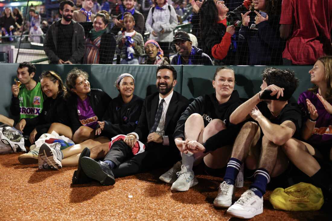 Zohran Mamdani sits with attendees to watch "The Cost of Living Classic" soccer tournament on October 19, 2025 in New York City.