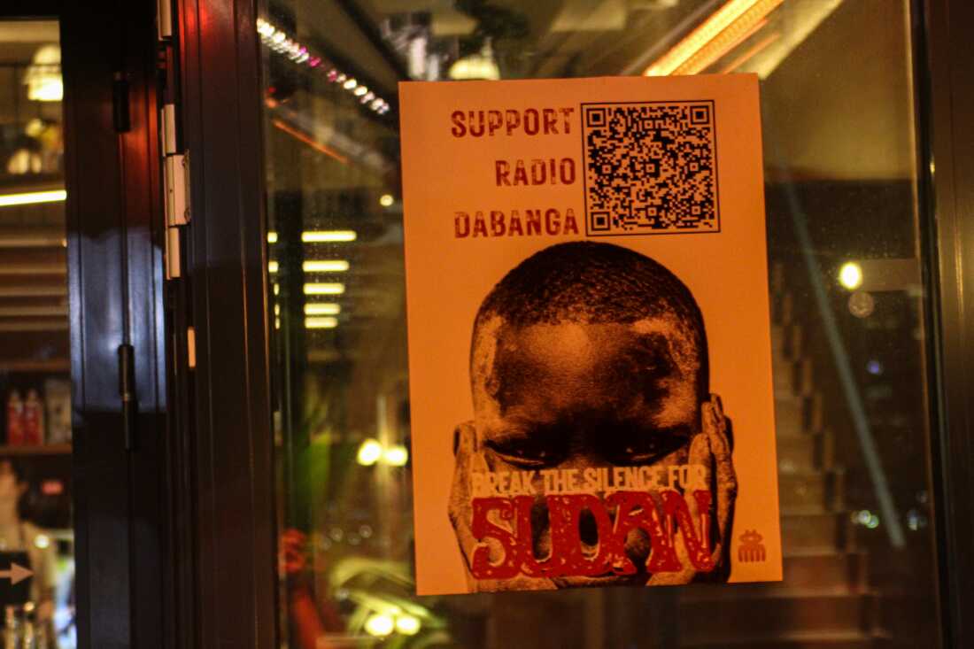 A poster advertises a fundraiser for Radio Dabanga, a station dedicated to news from Sudan, on a restaurant window in Amsterdam on Oct. 22.