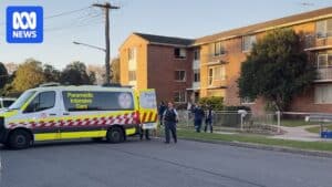 Paramedics and police at the Hassall Street unit block in Hamilton South