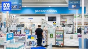 Community pharmacy storefront and signage, representing pharmacies discussed in the report.