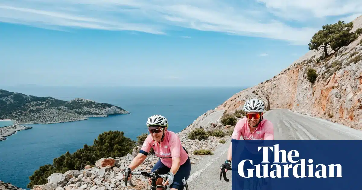 Sam Wood with a cyclist on Symi, Greece during a Bike Odyssey tour retracing Homer's Odyssey