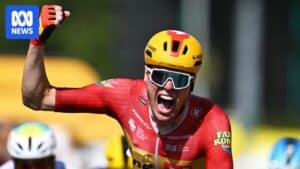 Soeren Waerenskjold celebrating at the finish line after winning stage 11 of the Tour de France