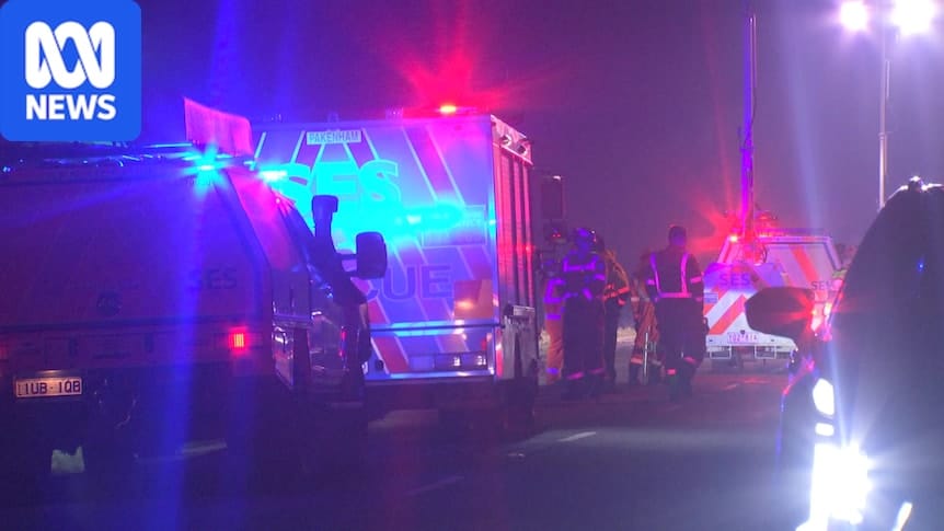 Emergency services at the Catani crash scene at night beside a car that left the road and flipped into a drainage culvert