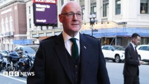 Swinney Defends World Cup Business-Class Flight Costs