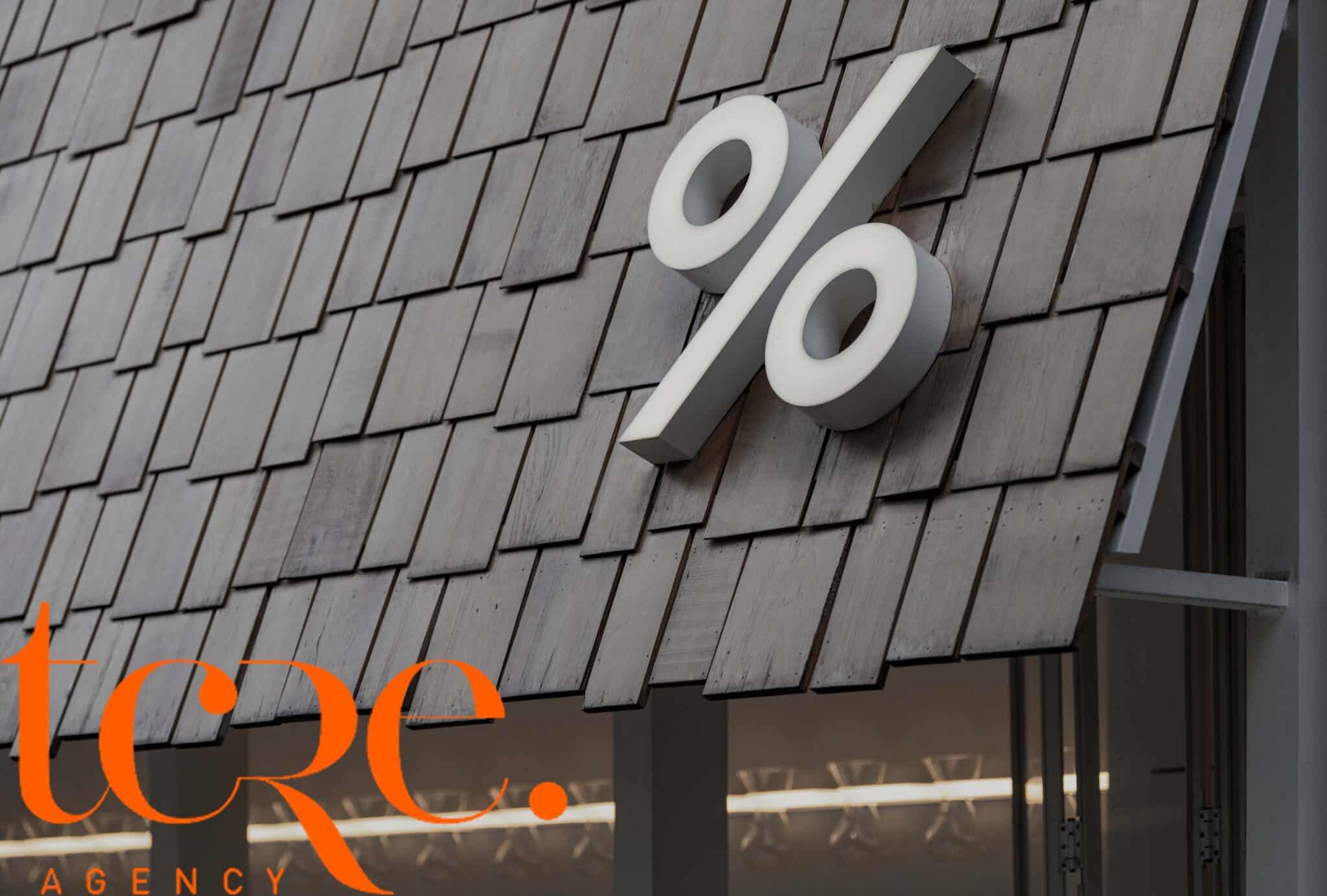 Percentage symbol on a building with Town & Country Real Estate branding.