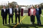 Guests beside the commemorative plaque at the Newington Reserve upgrade opening.