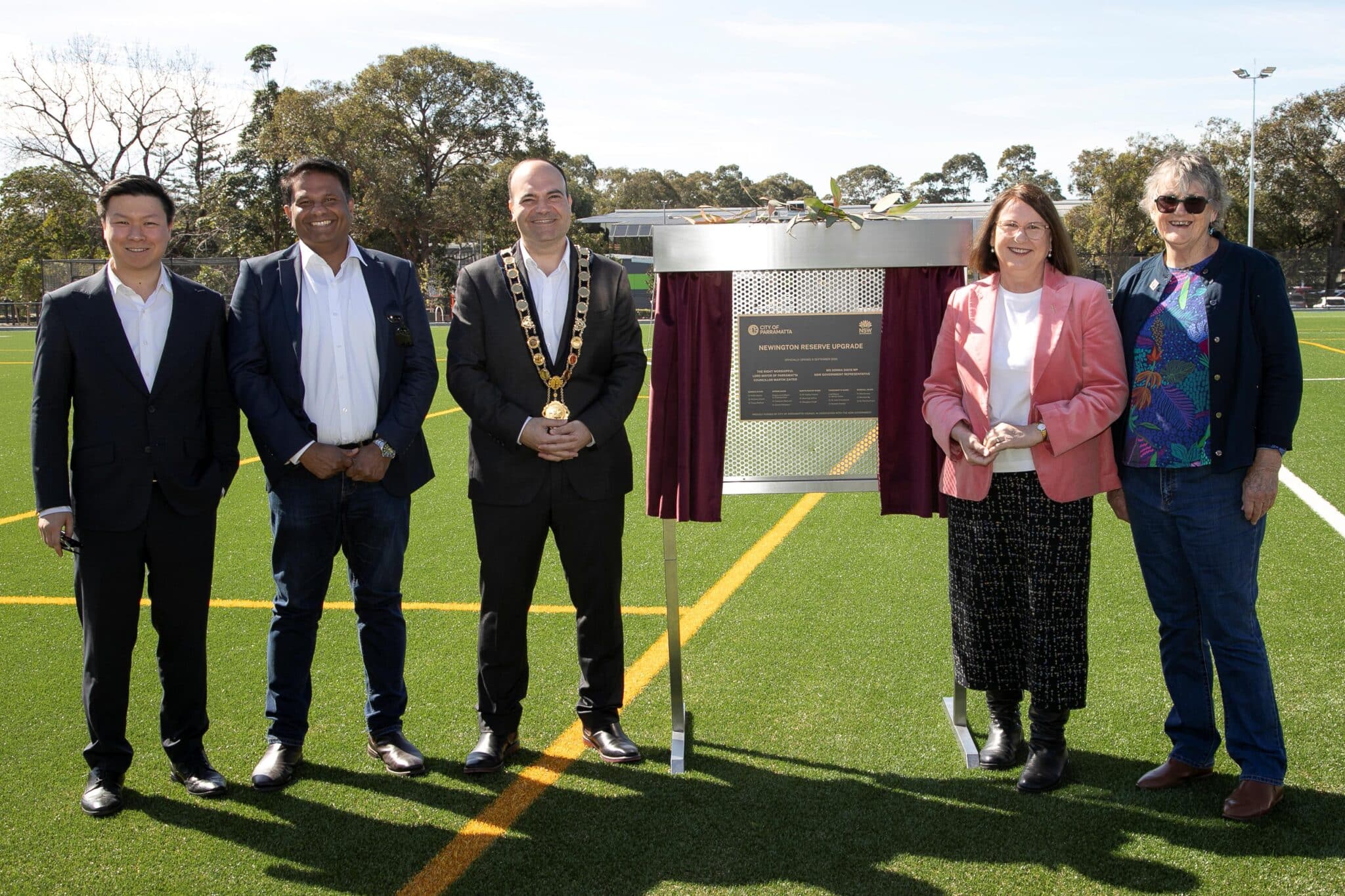 Guests beside the commemorative plaque at the Newington Reserve upgrade opening.